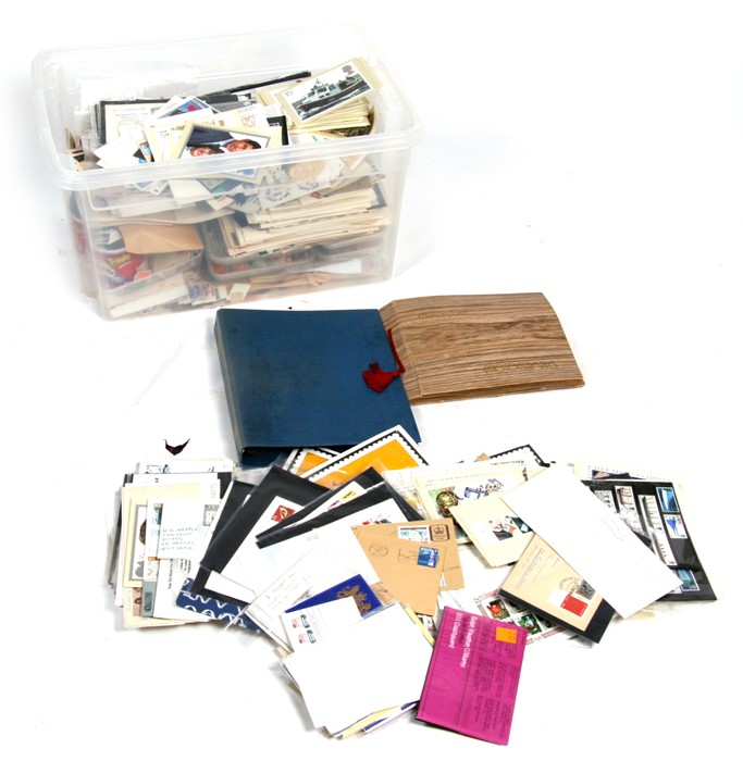 STAMPS: A massive quantity of loose stamps and first day covers contained in a plastic storage box