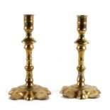 A pair of 17th / 18th century brass candlesticks, 20cms (8ins) high.