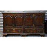 A large oak mule chest with panelled doors above two long drawers, on bracket feet, 163cms (64ins)