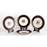 A set of four Victorian Chamberlain plates decorated with flowers within a blue and gilt border,