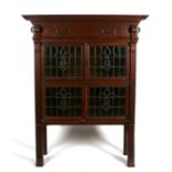 A Victorian oak cabinet with two pairs of leaded glass doors, on square legs, 111cms (43.5ins)