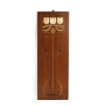An Art Nouveau oak panel inlaid with stylised flowers, 22 by 62cms (8.5 by 24.5ins).