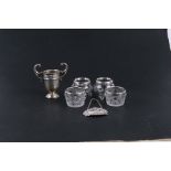 Two pairs of silver rimmed salts; together with a small silver trophy and a silver gin bottle