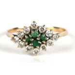 A 9ct gold dress ring set with emeralds and white stones, approx UK size 'P'.