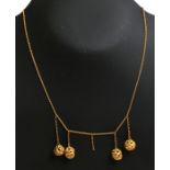 A yellow metal (tests as 15ct gold) necklace with pierced ball drops, total weight 5.5g.Condition