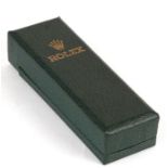 A green leather Rolex wristwatch case.