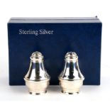A boxed set of silver salt and pepper.