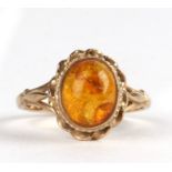A 9ct gold and amber dress ring, approx UK size 'O'.Condition ReportThis item has a crack to the