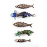 Two Chinese white metal and enamel articulated fish pendants; together with three white metal