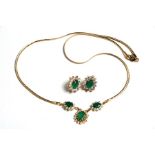 An 18ct gold emerald and white stone (possibly a white sapphire) necklace and matching earrings,