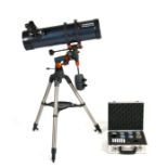 A Celestron Astromaster 130 astronomical telescope; together with a case of lenses.