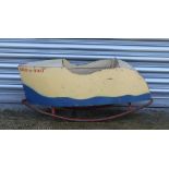 A child's vintage painted wooden rocking boat.