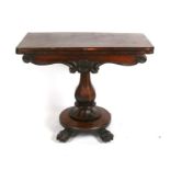An early 19th century rosewood fold-over card table on octagonal column, standing on lion paw