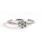 A 9ct white gold cluster ring with diamond set shoulders, approx UK size 'K'.