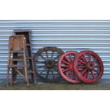 Three painted wooden spoked cart wheels; together with two small step ladders.Condition ReportPair