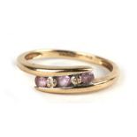 A 9ct gold ring set with three pale pink stones interspersed with two diamonds, approx UK size 'M'.