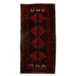 A Caucasian Kazak rug with central geometric design on red and blue fields, 174 by 90cms (68.5 by