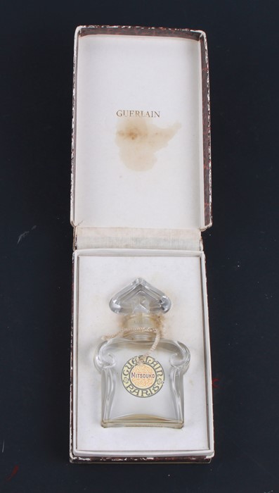 A Guerlain Mitsouko glass scent bottle in original cardboard box.