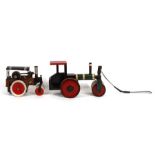 A Mamod style steam roller, 24cms (9.5ins) long; together with a painted wooden pull-along steam