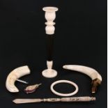 An early 20th century turned ivory and rosewood candlestick; together with a pierced bone letter