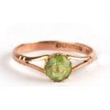 A 9ct gold ring set with a single green stone, possibly a peridot, approx UK size 'Q'.