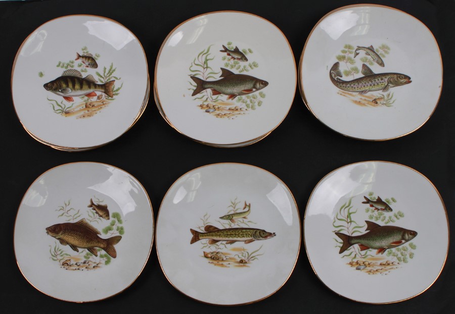 A quantity of Limoges plates, each decorated with fish, 23cms (9ins) diameter (12).