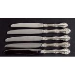 Five sterling silver handled knives by Birks.