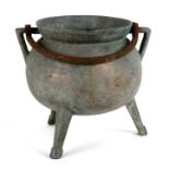An antique two-handled tripod cauldron, 24cms (9.5ins) high.
