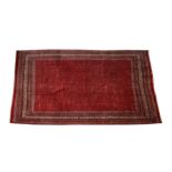 A Persian Arak woollen hand knotted carpet with all over design on a red and cream ground, 383 by