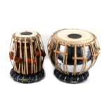 Two leather bound bongo drums.