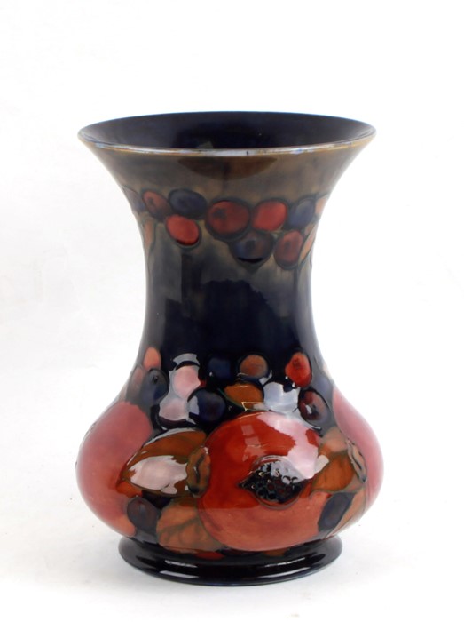 A Moorcroft Pottery vase decorated with fruit, 21cms (8.25ins) high.Condition Report Crazing to