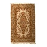 A Caucasian woollen hand knotted rug with foliate design on a beige ground, 147.3 by 94.5cms (58