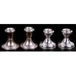 Two pairs of silver dwarf candlesticks.