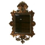 A gilded wall mirror with rectangular bevelled plate, 65cms (25.5ins) wide.