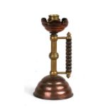 An Arts & Crafts copper & brass candlestick of Christopher Dresser design, 21cms |(8.25ins) high.