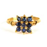 A yellow metal (tests as 14ct gold) tanzanite cluster ring, approx UK size 'P'.
