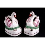 A pair of mid 19th century pink lustre swan quill holder inkwells, each depicted seated upon a nest.