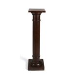 A mahogany torchere on turned & reeded column, 107cms (42ins) high.