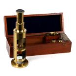 A Victorian lacquered brass student's microscope and slides, in a mahogany case.