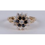A 9ct gold sapphire and white stone cluster ring, approx UK size 'S'.
