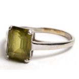 A 9ct white gold dress ring set with a large square green stone, approx UK size 'R'.