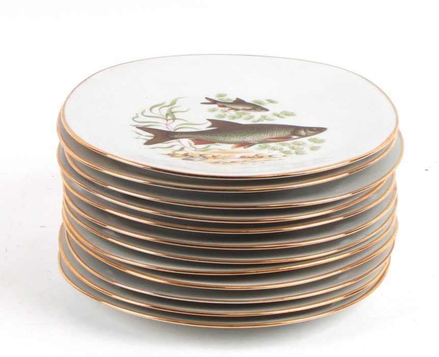 A quantity of Limoges plates, each decorated with fish within a gilded border, 24cms (9.5ins) - Image 2 of 2