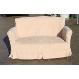 An Edwardian upholstered two-seater sofa, 140cms (55ins) wide.