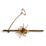 A large 9ct gold stock pin having a gem set spider to the centre, weight 7.4g, 7.5cms (3ins) wide.