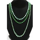 A group of green glass and jade like bead necklaces.