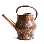 A large copper water can decorated with foliate scrolls, 36cms (14ins) high.