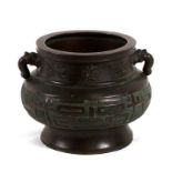 A 19th century Japanese bronze two-handled censer, 25cms (9.75ins) diameter.