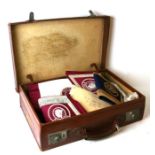 A suitcase containing Masonic regalia to include aprons and jewels.