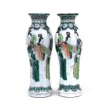 A pair of Chinese famille verte vases decorated with figures, four character mark to underside,