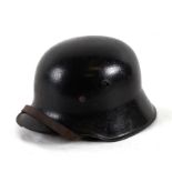 An M16 Third Reich German helmet with hand painted Freikorps Swastika to front centre, complete with